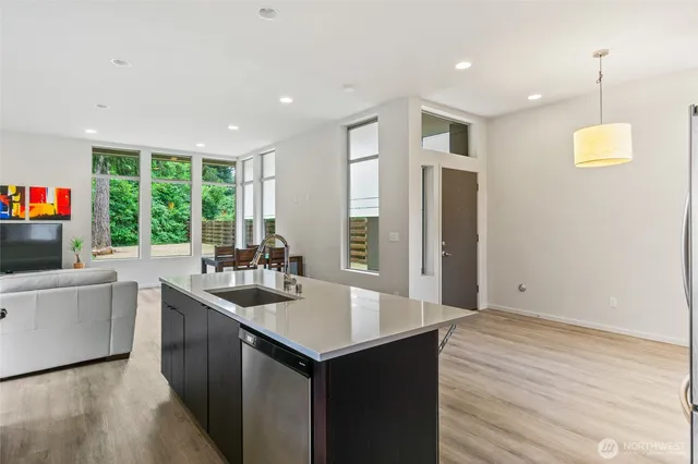 a kitchen with a sink cabinets and wooden floor