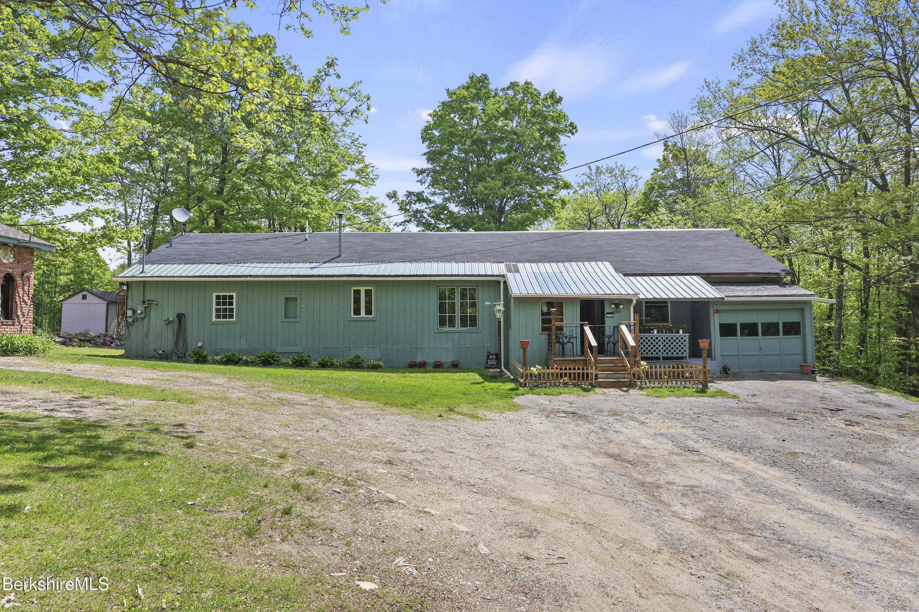 192 Curran Road Cheshire, MA 01225 - Photo 2 of 50 a front view of a house with a yard and trees