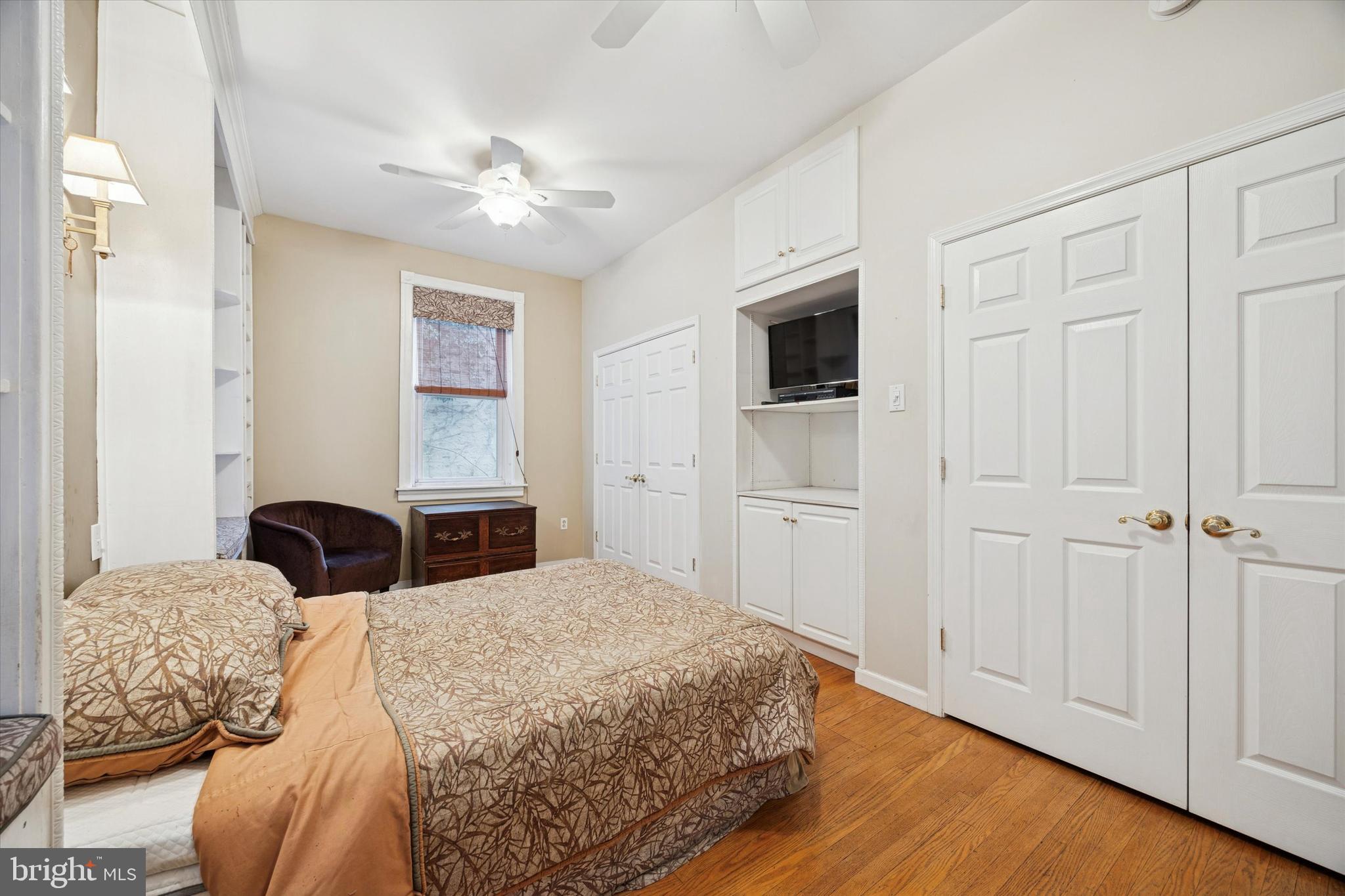 1605 South 8th Street Philadelphia, PA 19148 - Photo 12 of 26 a bedroom with a large bed and a chandelier