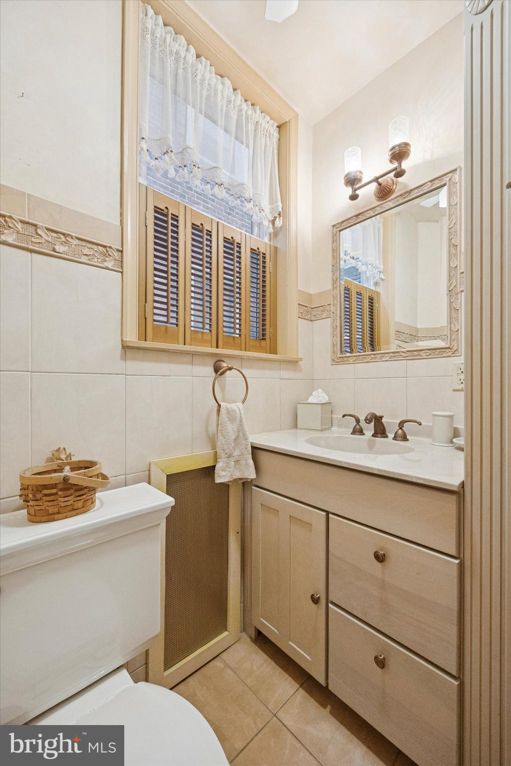 1605 South 8th Street Philadelphia, PA 19148 - Photo 14 of 26 a bathroom with a sink a toilet and a mirror