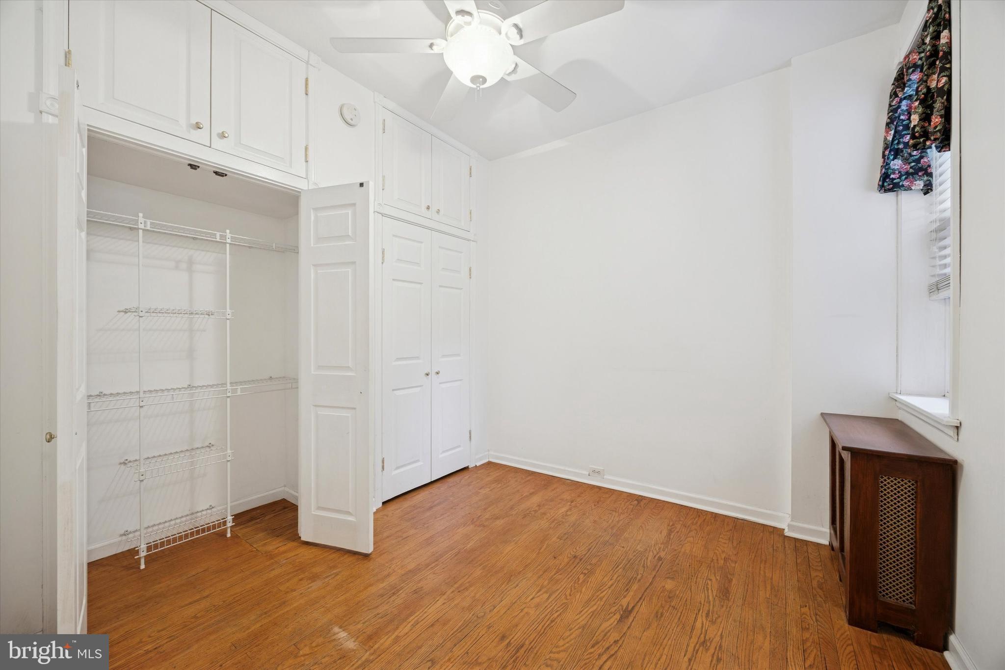 1605 South 8th Street Philadelphia, PA 19148 - Photo 16 of 26 wooden floor in an empty room with a window
