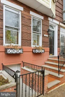 a front view of a house with outdoor seating