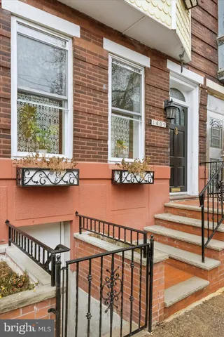 a front view of a house with outdoor seating