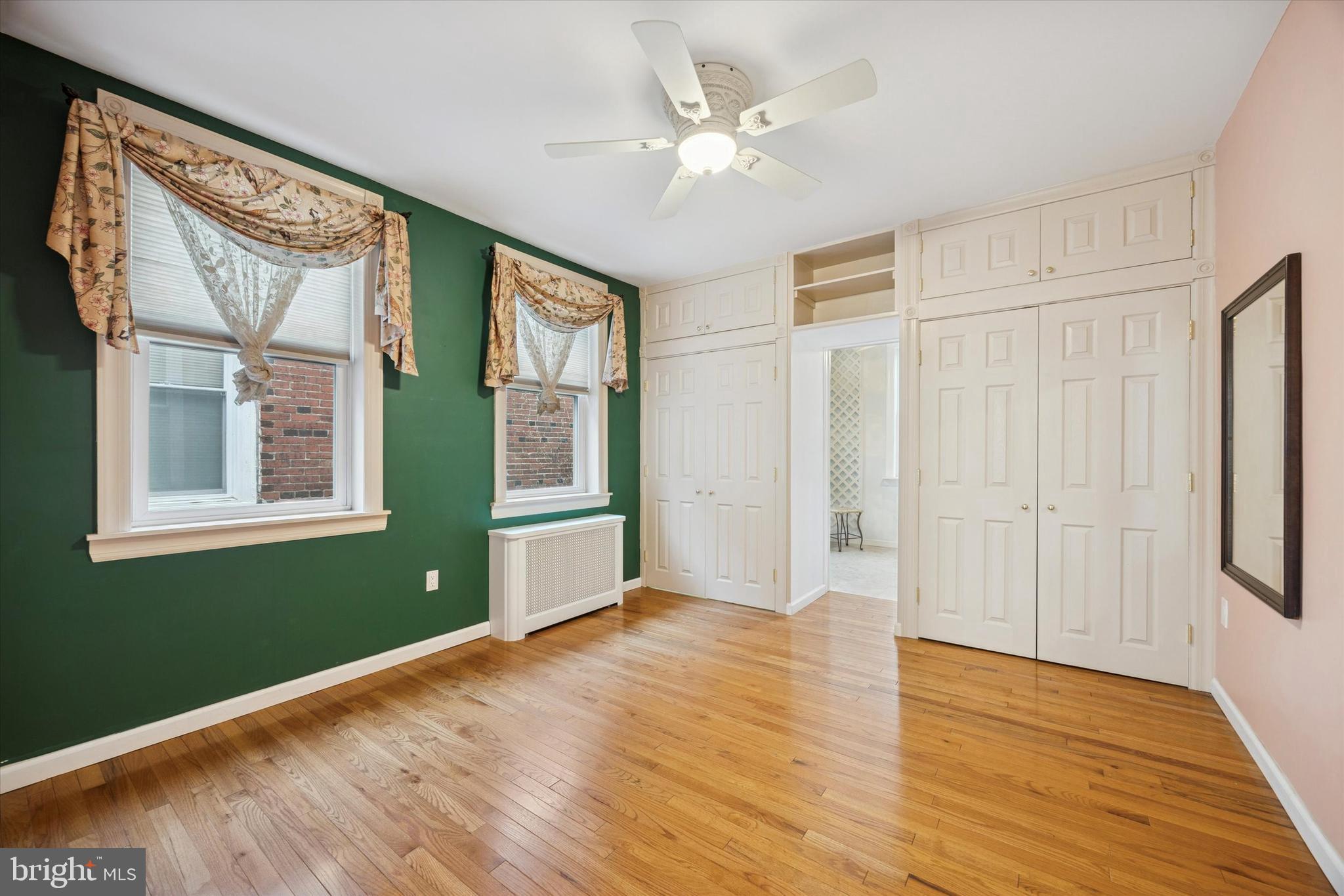1605 South 8th Street Philadelphia, PA 19148 - Photo 23 of 26 a view of an empty room with window and wooden floor