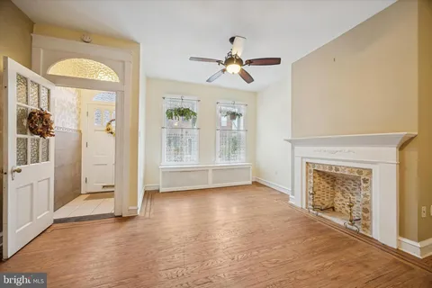 a view of an empty room with a fireplace and a window