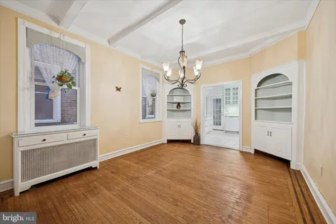a view of a livingroom with wooden floor and staircase