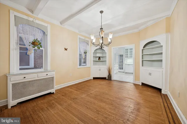a view of a livingroom with wooden floor and staircase