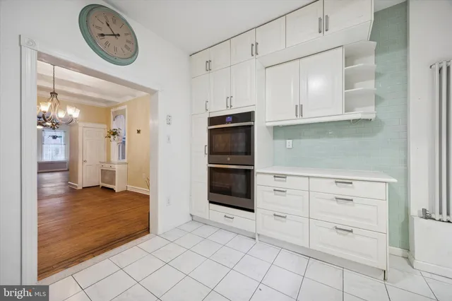 a view of kitchen with white cabinets