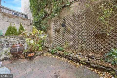 a backyard of a house with chairs and a fire pit