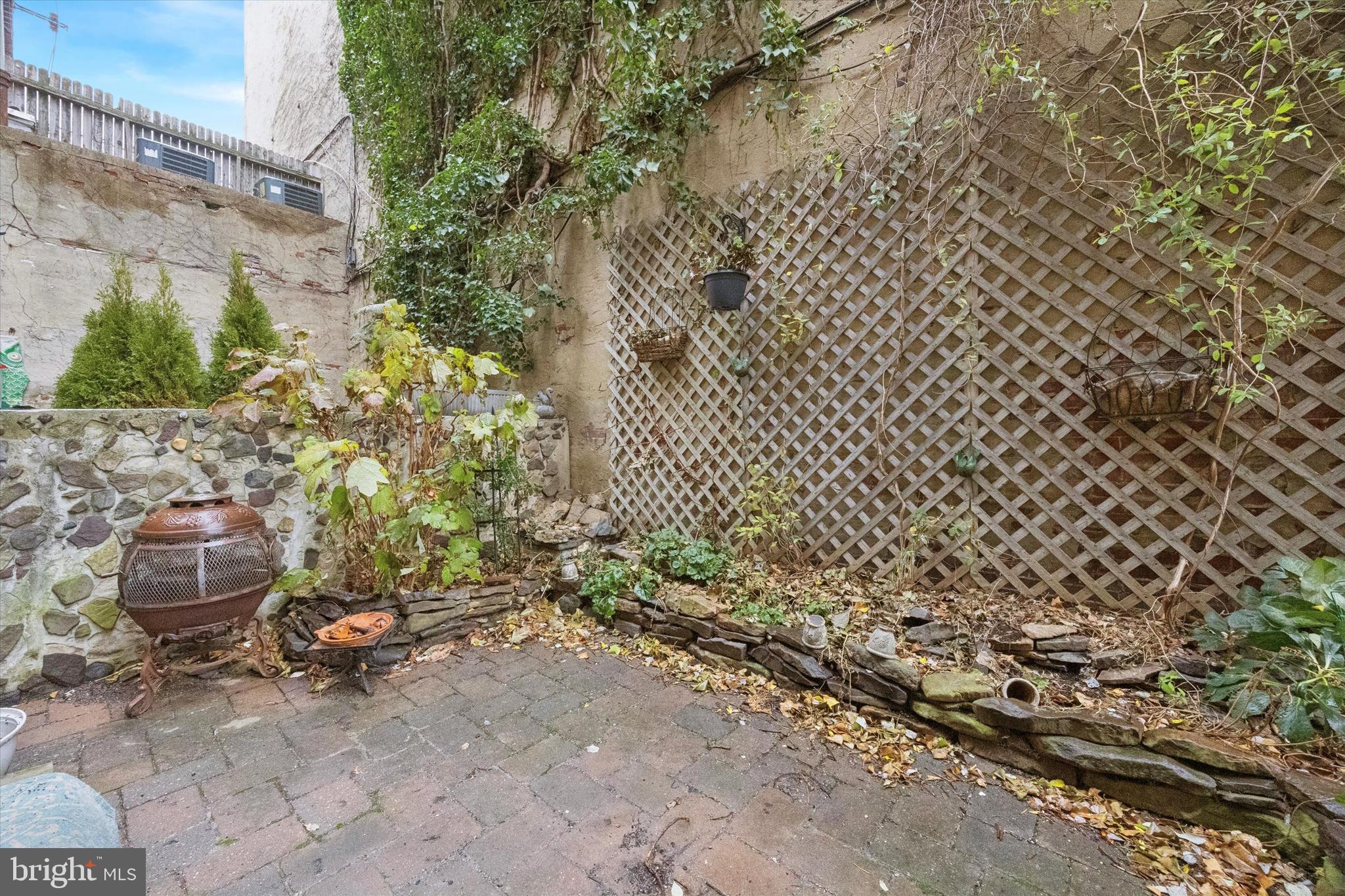 1605 South 8th Street Philadelphia, PA 19148 - Photo 10 of 26 a backyard of a house with chairs and a fire pit