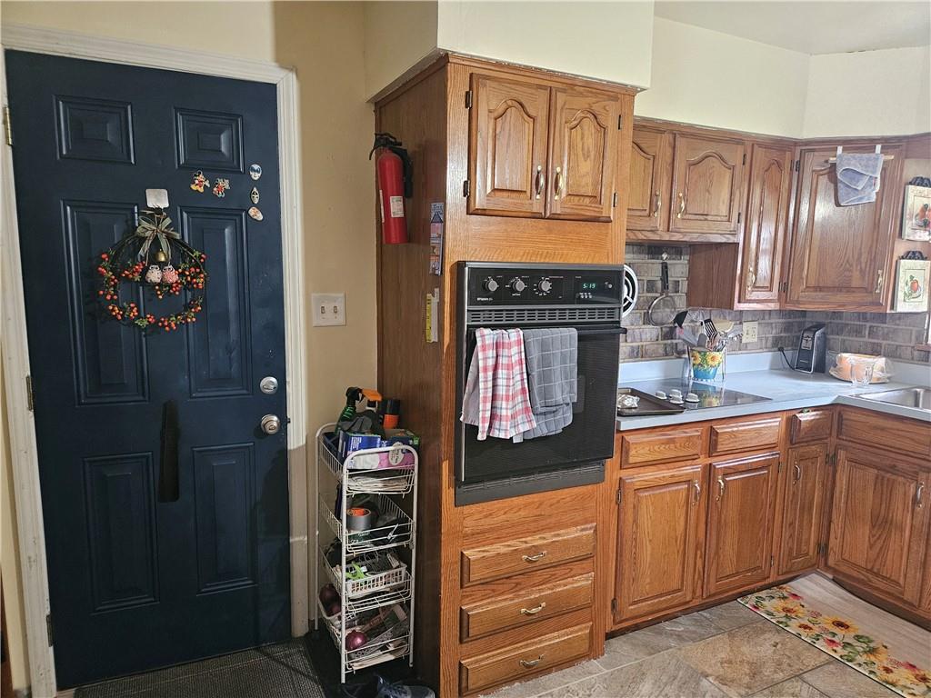 521 West Butler Street Mercer, PA 16137 - Photo 4 of 23 a kitchen with stainless steel appliances granite countertop a refrigerator and a stove top oven