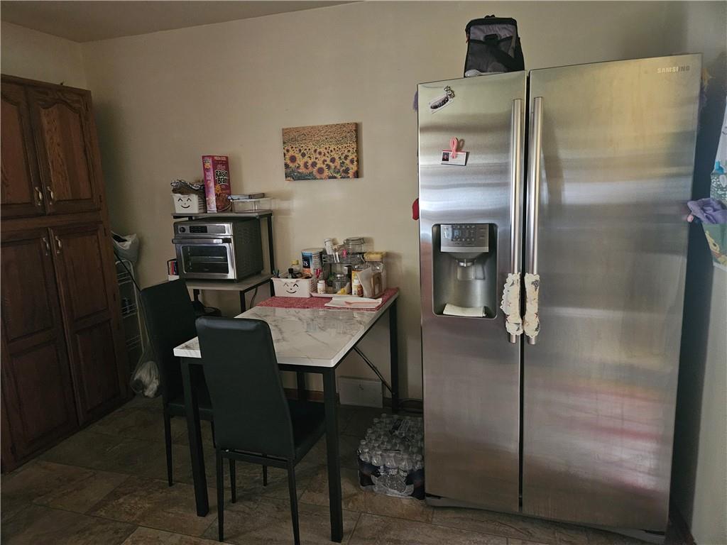 521 West Butler Street Mercer, PA 16137 - Photo 5 of 23 a kitchen with a refrigerator and table in it