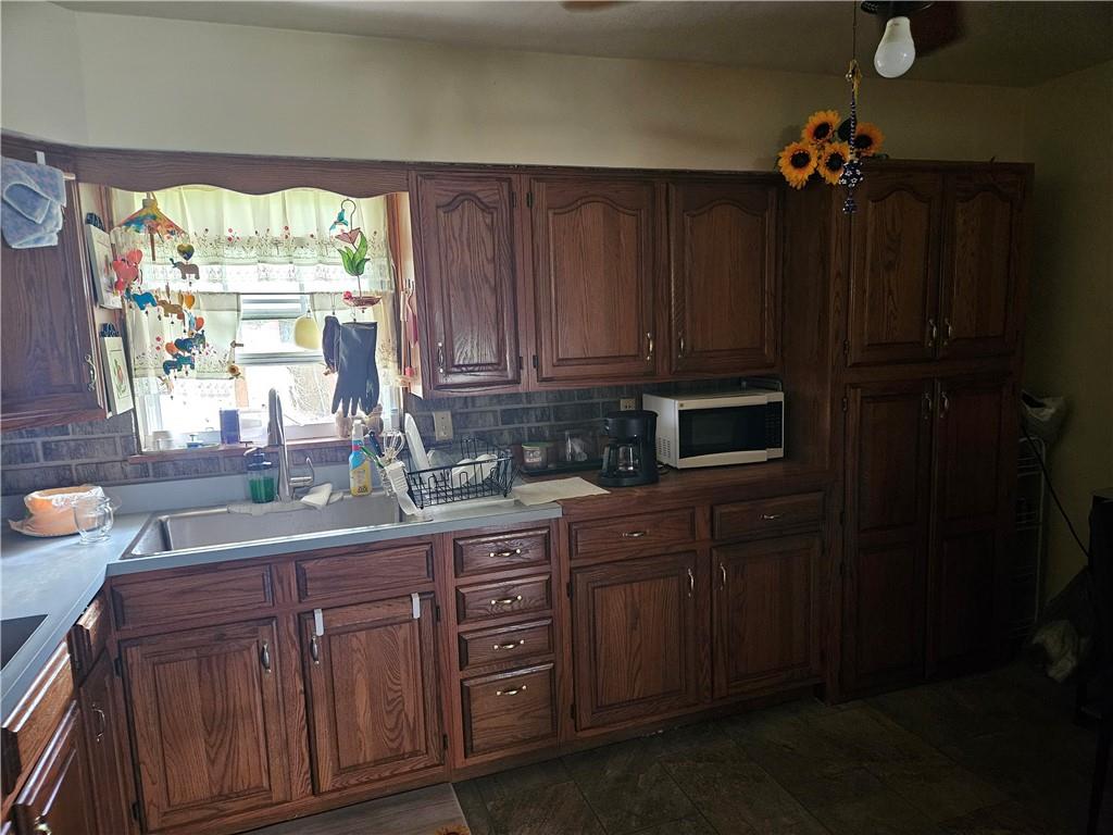 521 West Butler Street Mercer, PA 16137 - Photo 6 of 23 a kitchen with a sink a window and cabinets