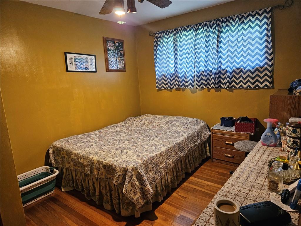 521 West Butler Street Mercer, PA 16137 - Photo 8 of 23 a bedroom with a bed and wooden floor