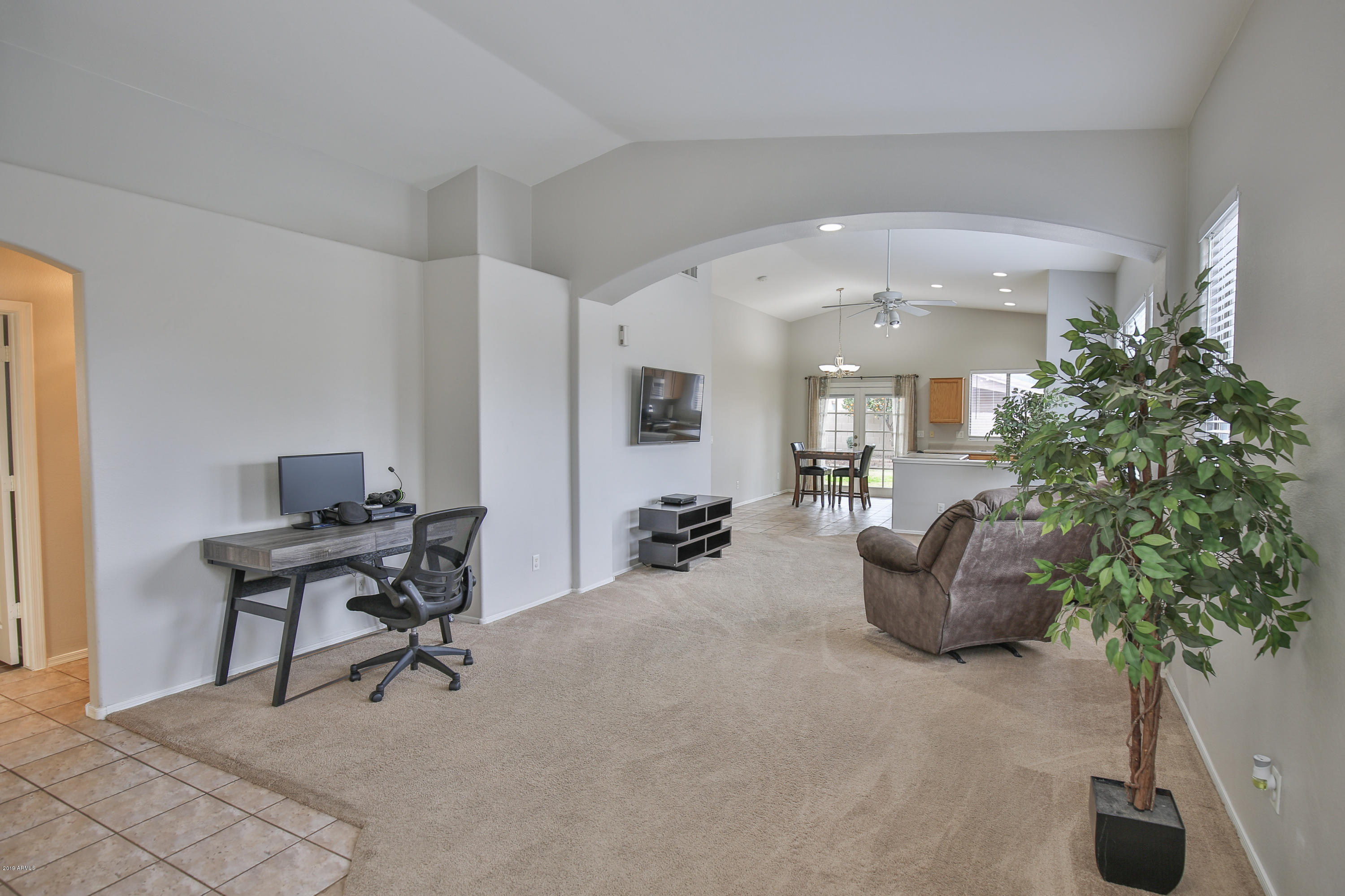 4328 South Rim Court Gilbert, AZ 85297 - Photo 11 of 36 a living room with furniture and potted plants