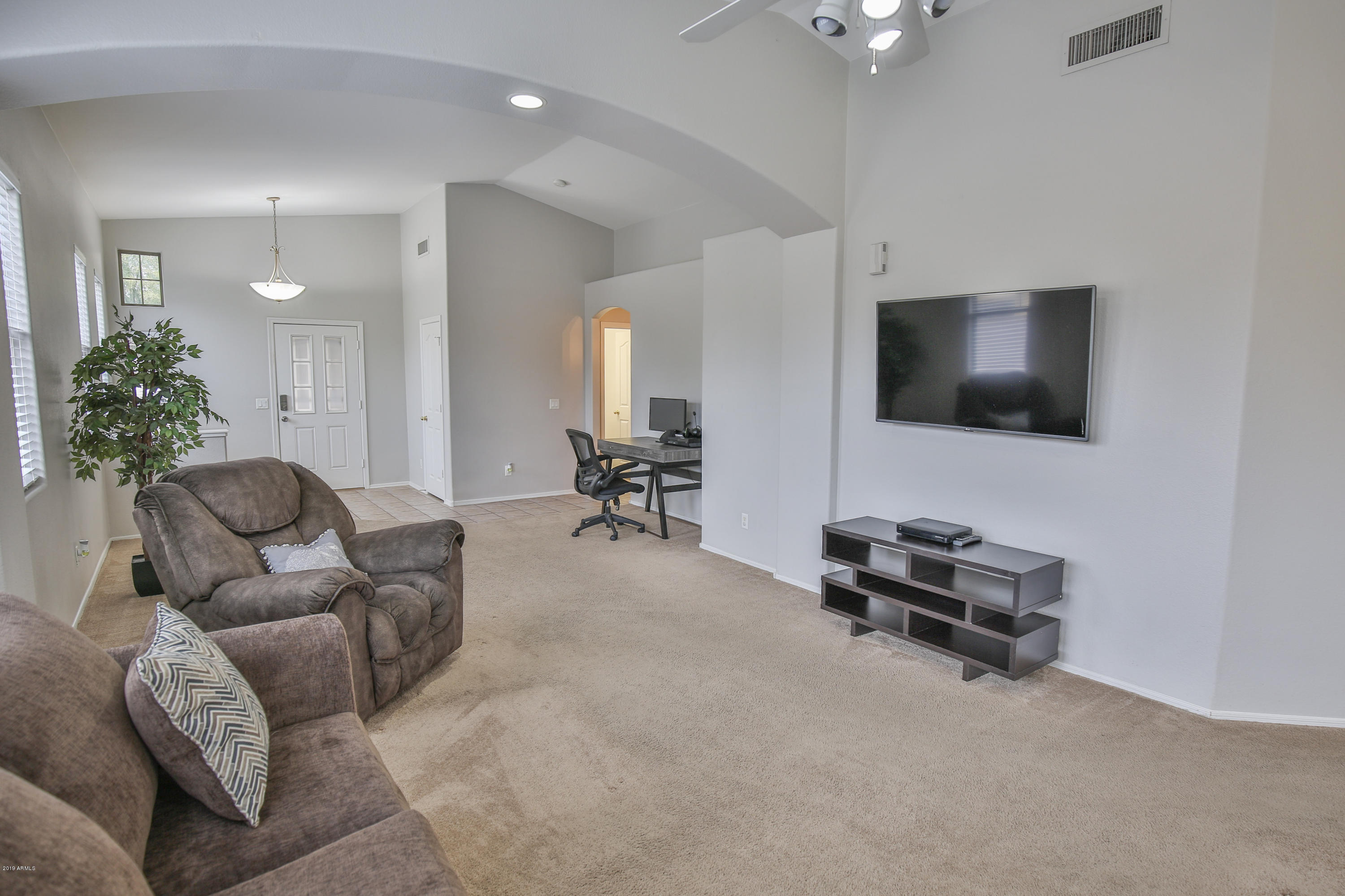 4328 South Rim Court Gilbert, AZ 85297 - Photo 12 of 36 a living room with furniture and a flat screen tv