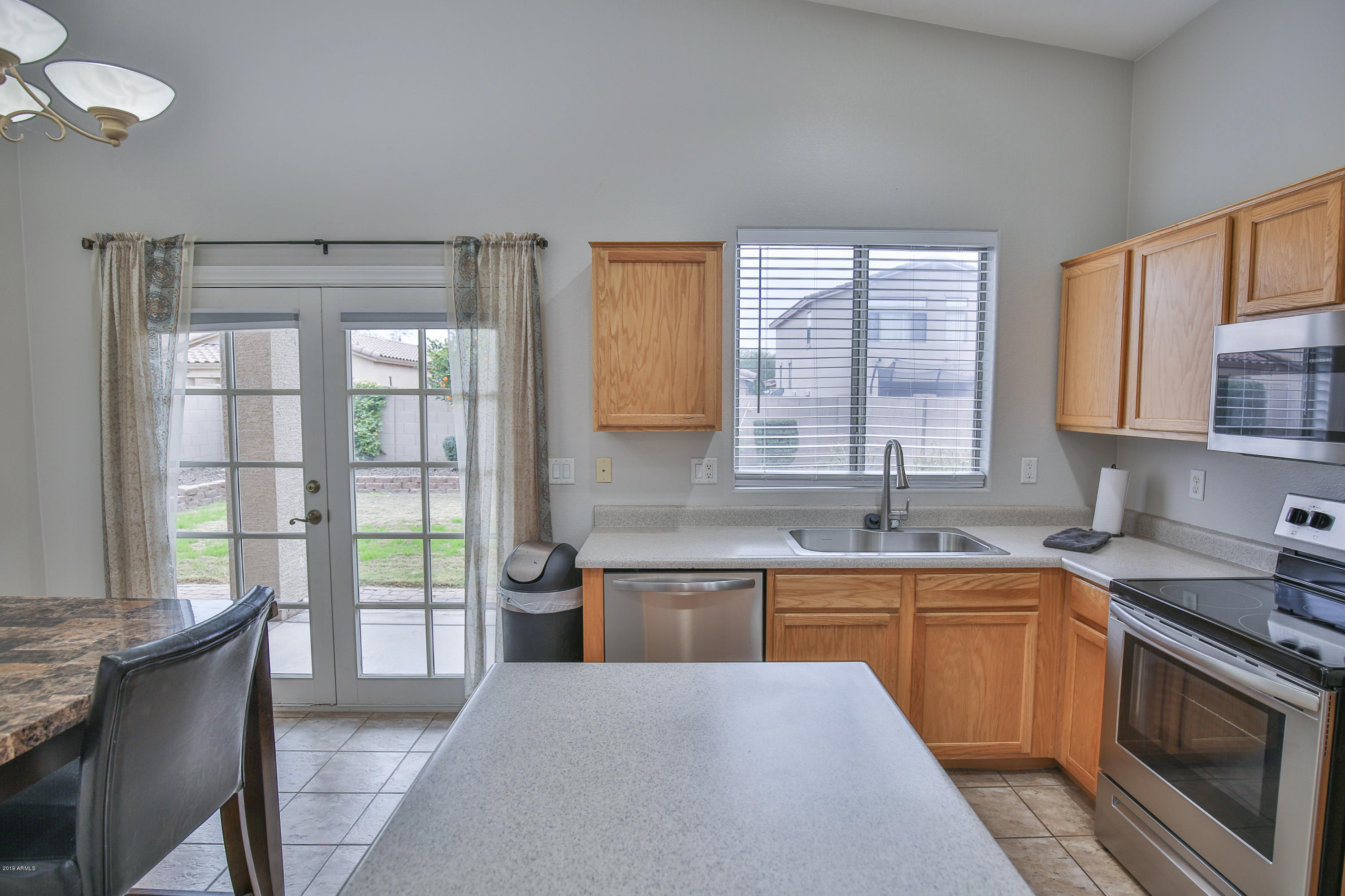 4328 South Rim Court Gilbert, AZ 85297 - Photo 13 of 36 a kitchen with a sink stove and cabinets