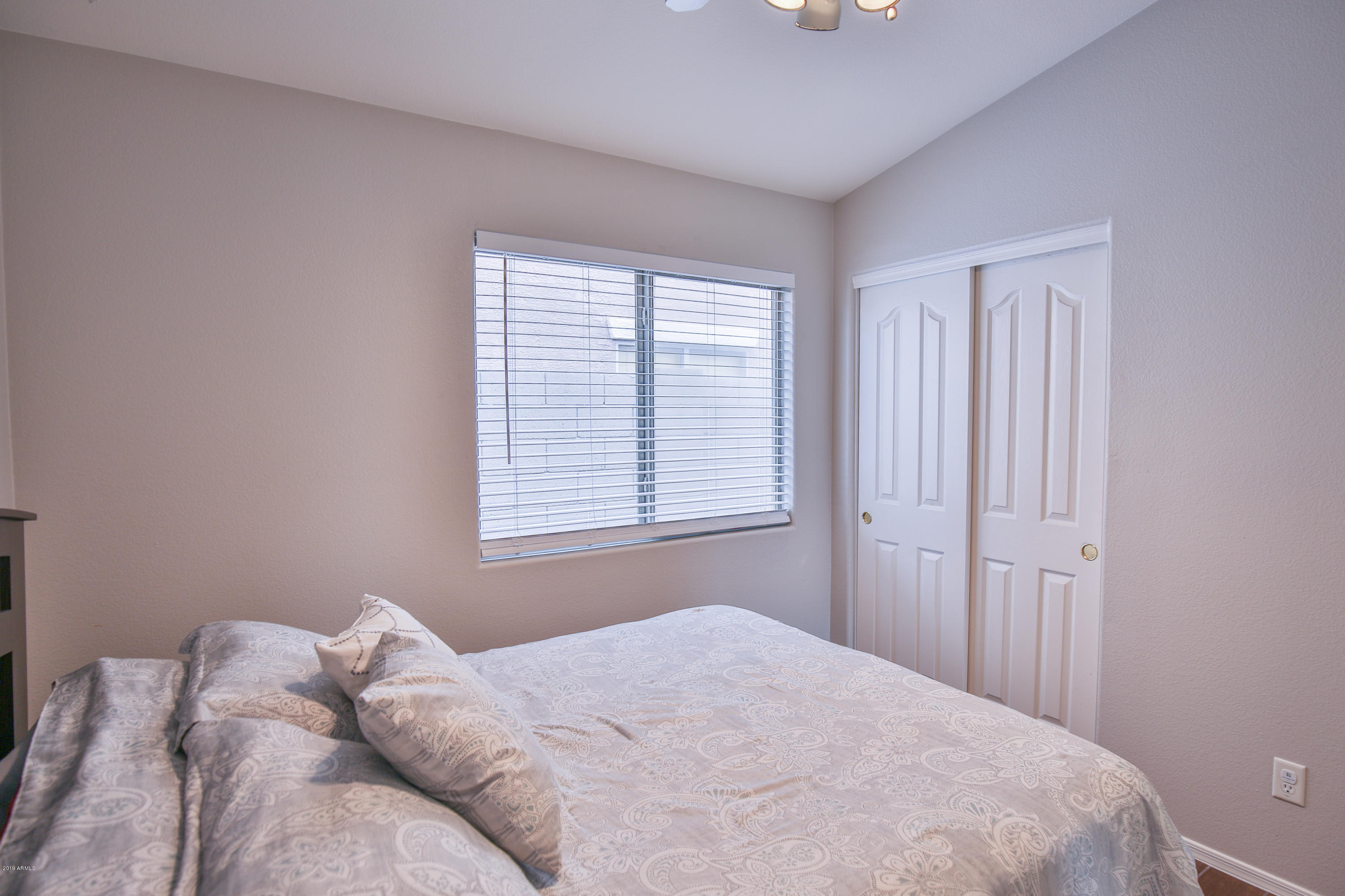 4328 South Rim Court Gilbert, AZ 85297 - Photo 24 of 36 a bed sitting in a bedroom next to a window