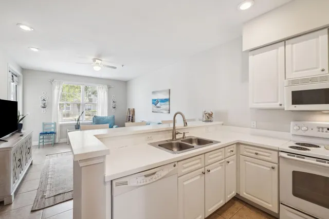 a kitchen with appliances a sink and cabinets