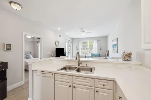 a kitchen with a sink and white cabinets