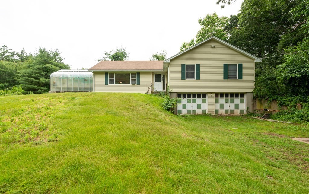 2 Leslie Road Ipswich, MA 01938 - Photo 3 of 26 a front view of a house with a garden