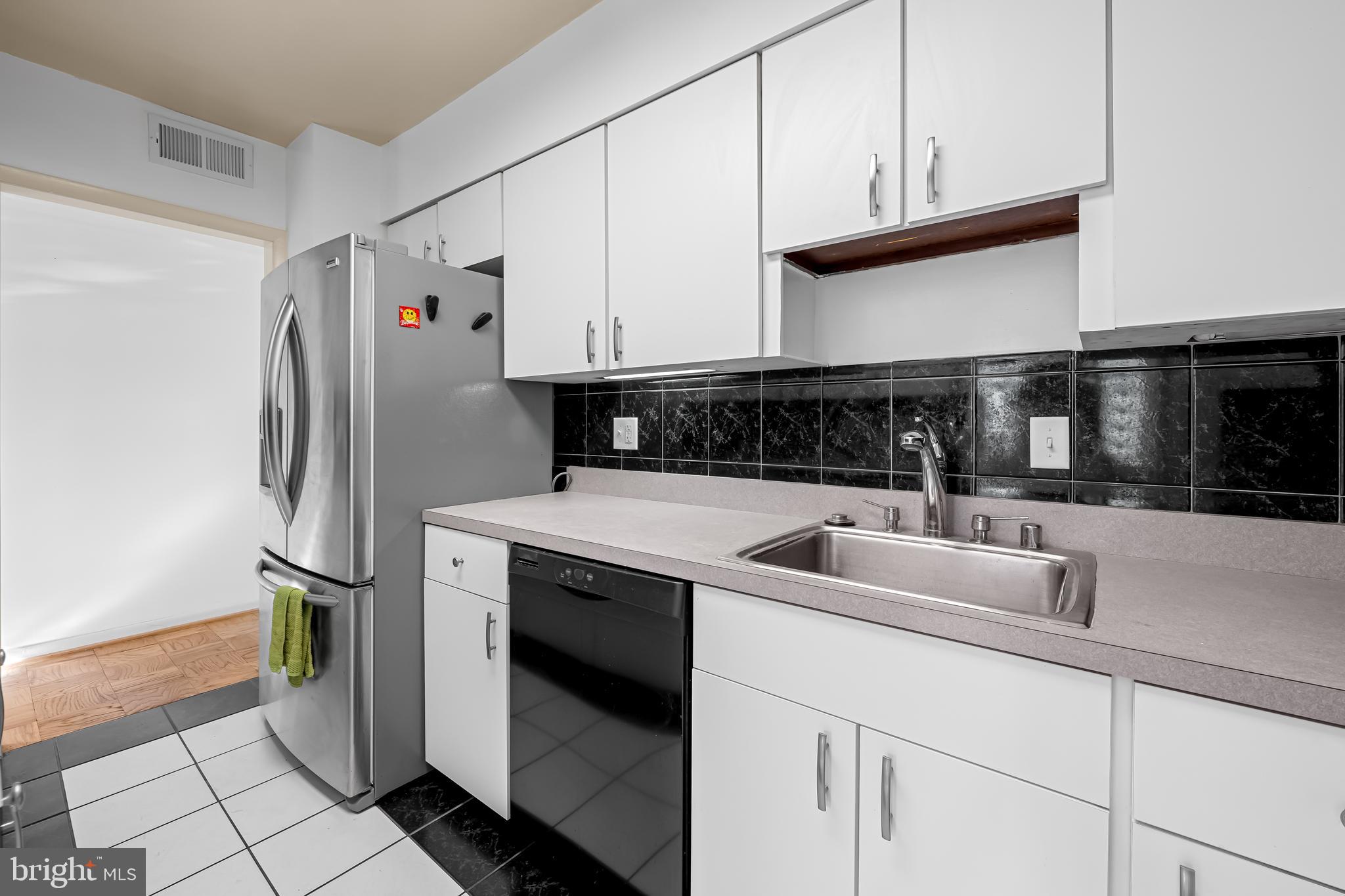 17 Hamill Road, Unit F Baltimore, MD 21210 - Photo 11 of 47 a kitchen with stainless steel appliances granite countertop a sink and a refrigerator