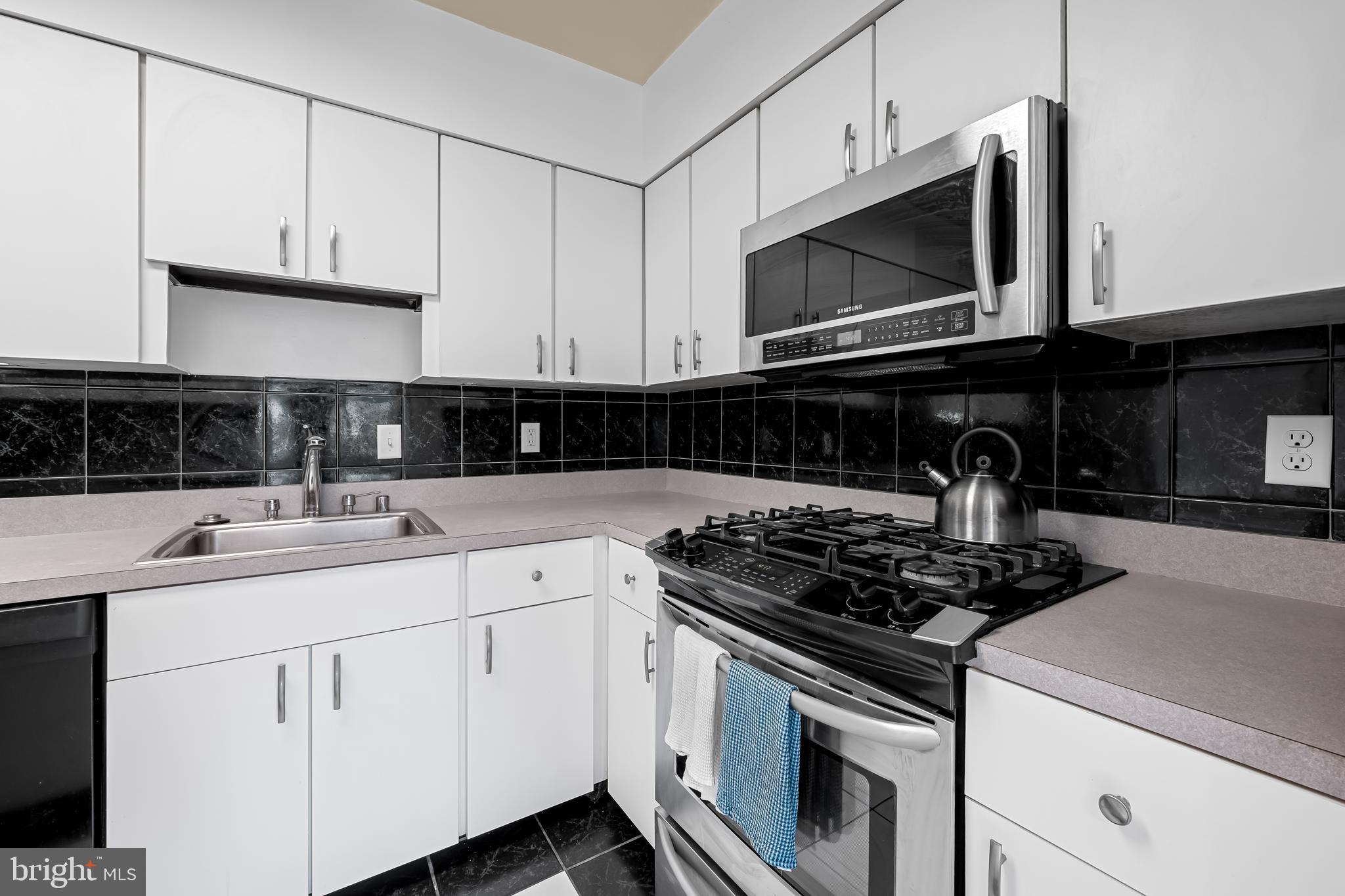 17 Hamill Road, Unit F Baltimore, MD 21210 - Photo 12 of 47 a kitchen with appliances a sink and cabinets