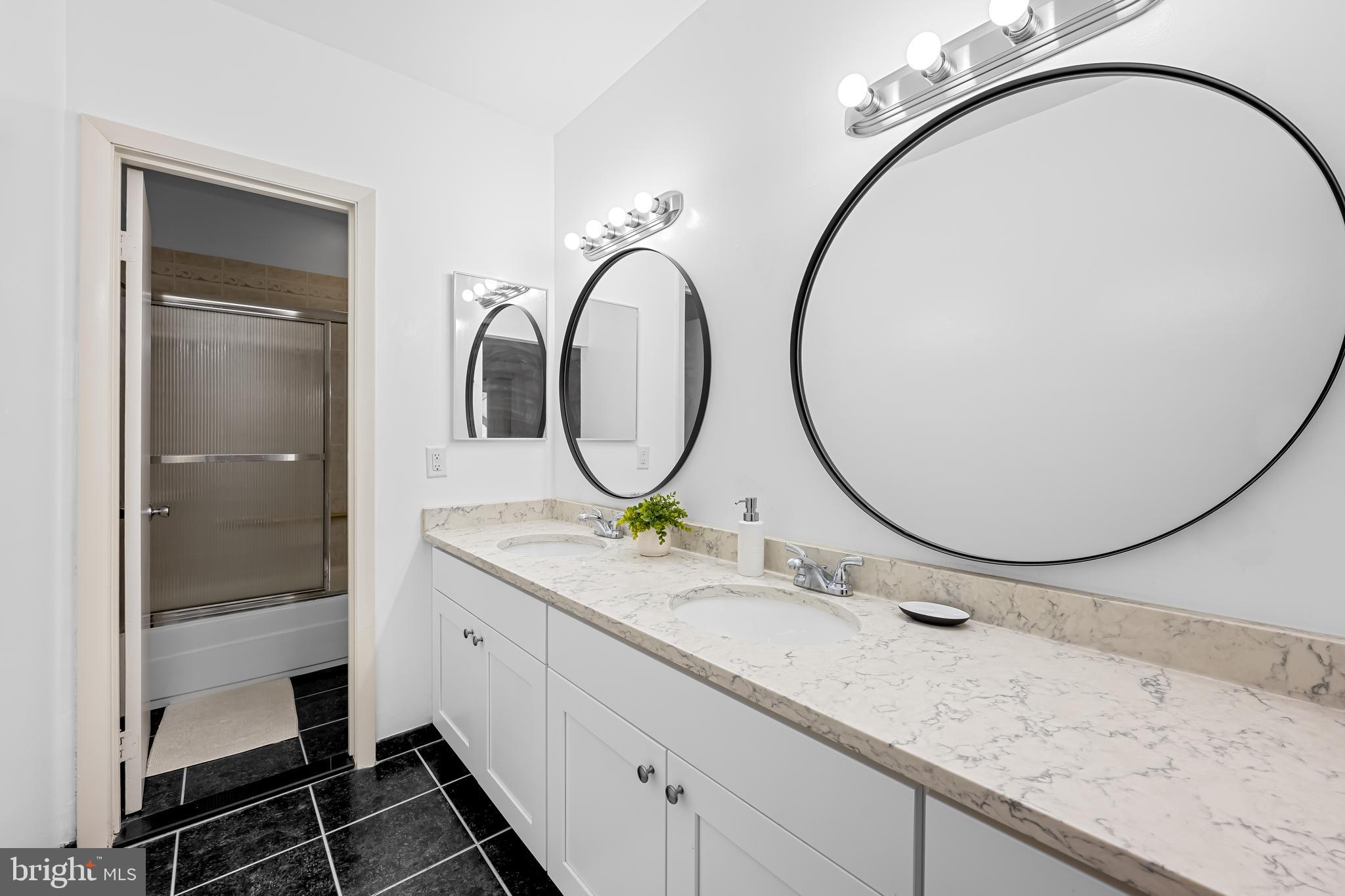17 Hamill Road, Unit F Baltimore, MD 21210 - Photo 24 of 47 a bathroom with a granite countertop double vanity sink and a mirror