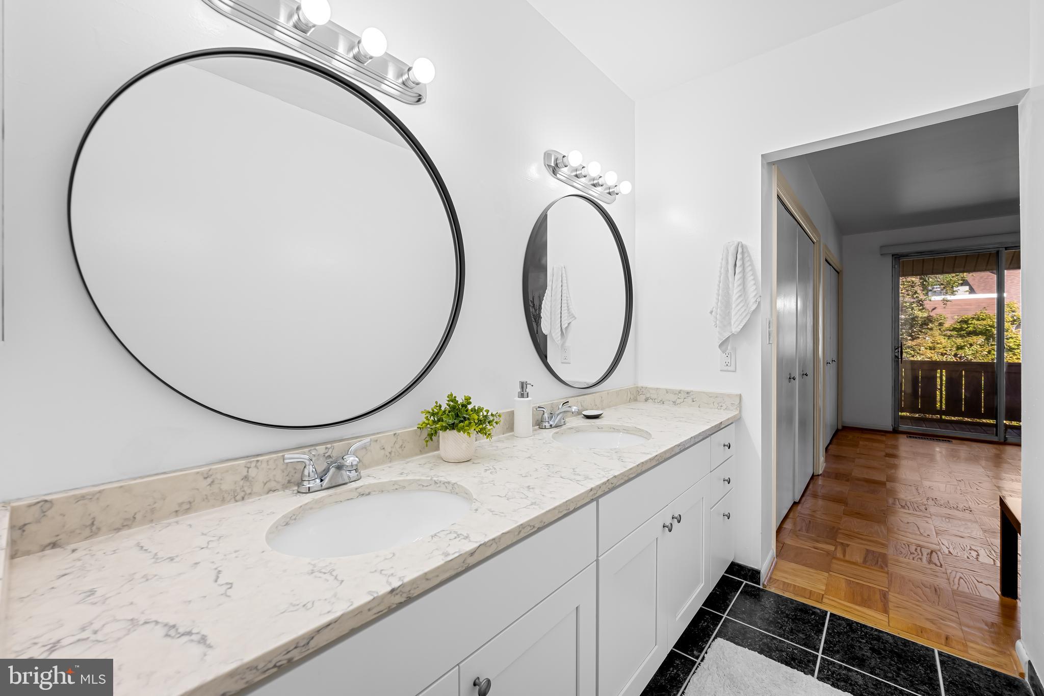 17 Hamill Road, Unit F Baltimore, MD 21210 - Photo 26 of 47 a bathroom with a granite countertop sink and a mirror