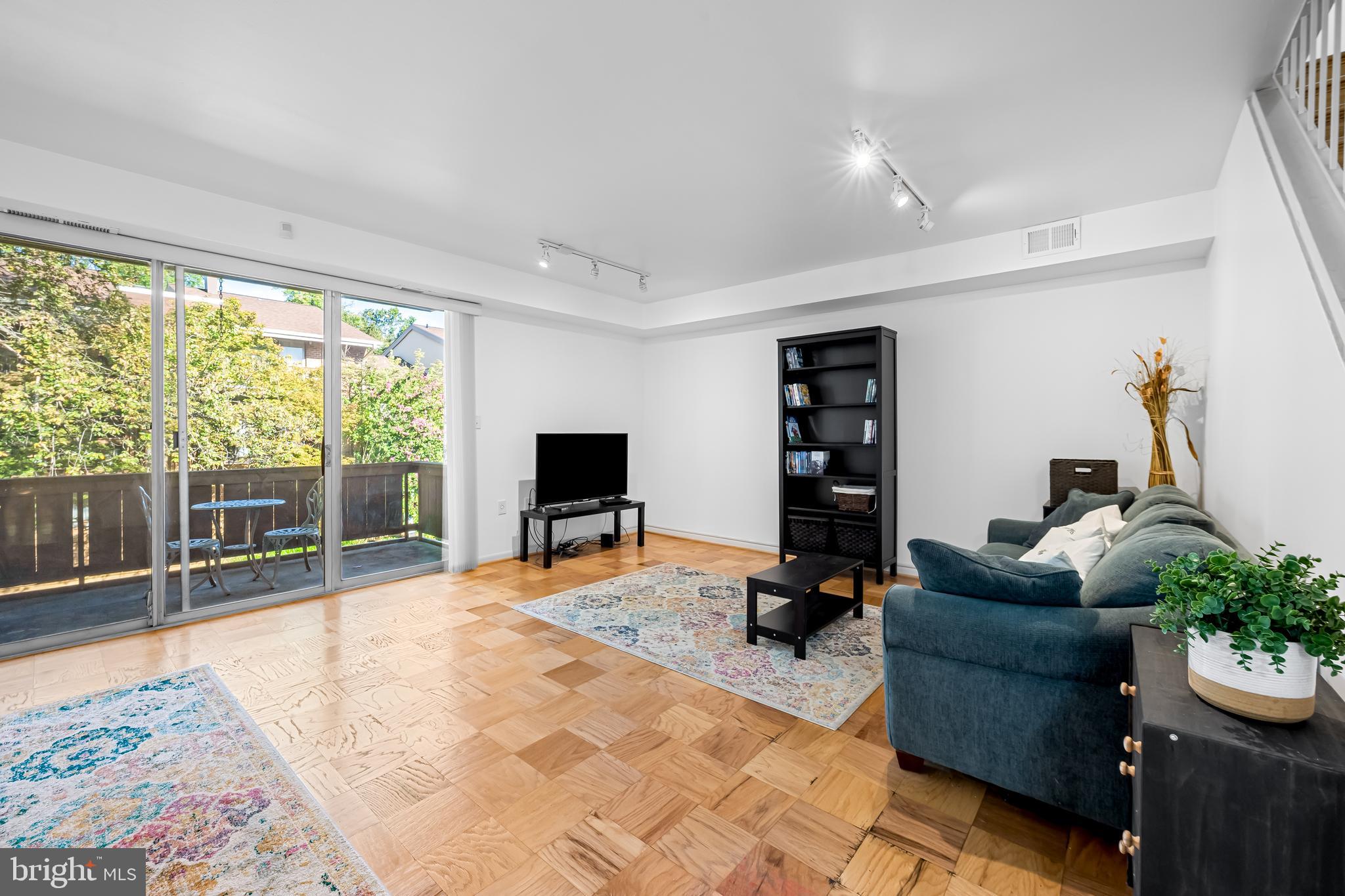 17 Hamill Road, Unit F Baltimore, MD 21210 - Photo 4 of 47 a living room with furniture a flat screen tv and a floor to ceiling window