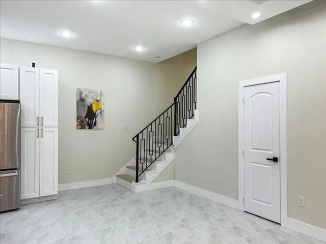 an open kitchen with a sink and a refrigerator