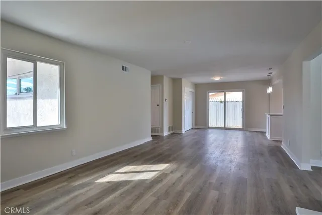 a kitchen with a refrigerator and white cabinets