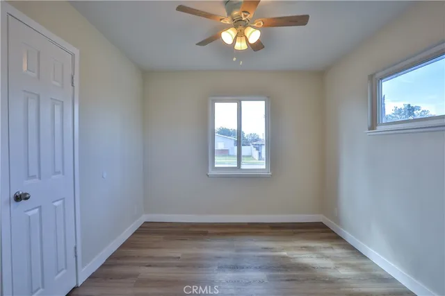 a view of a livingroom with wooden floor and a fireplace
