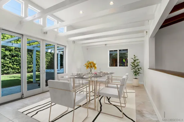 a dining room with furniture wooden floor and a potted plant