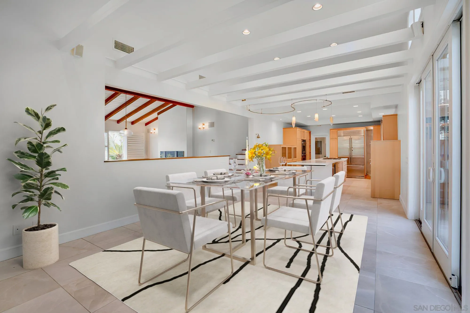 5247 Chelsea Street La Jolla, CA 92037 - Photo 9 of 29 a view of a dining room with furniture and a potted plant