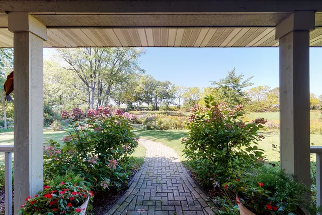a view of a chairs and table in the balcony