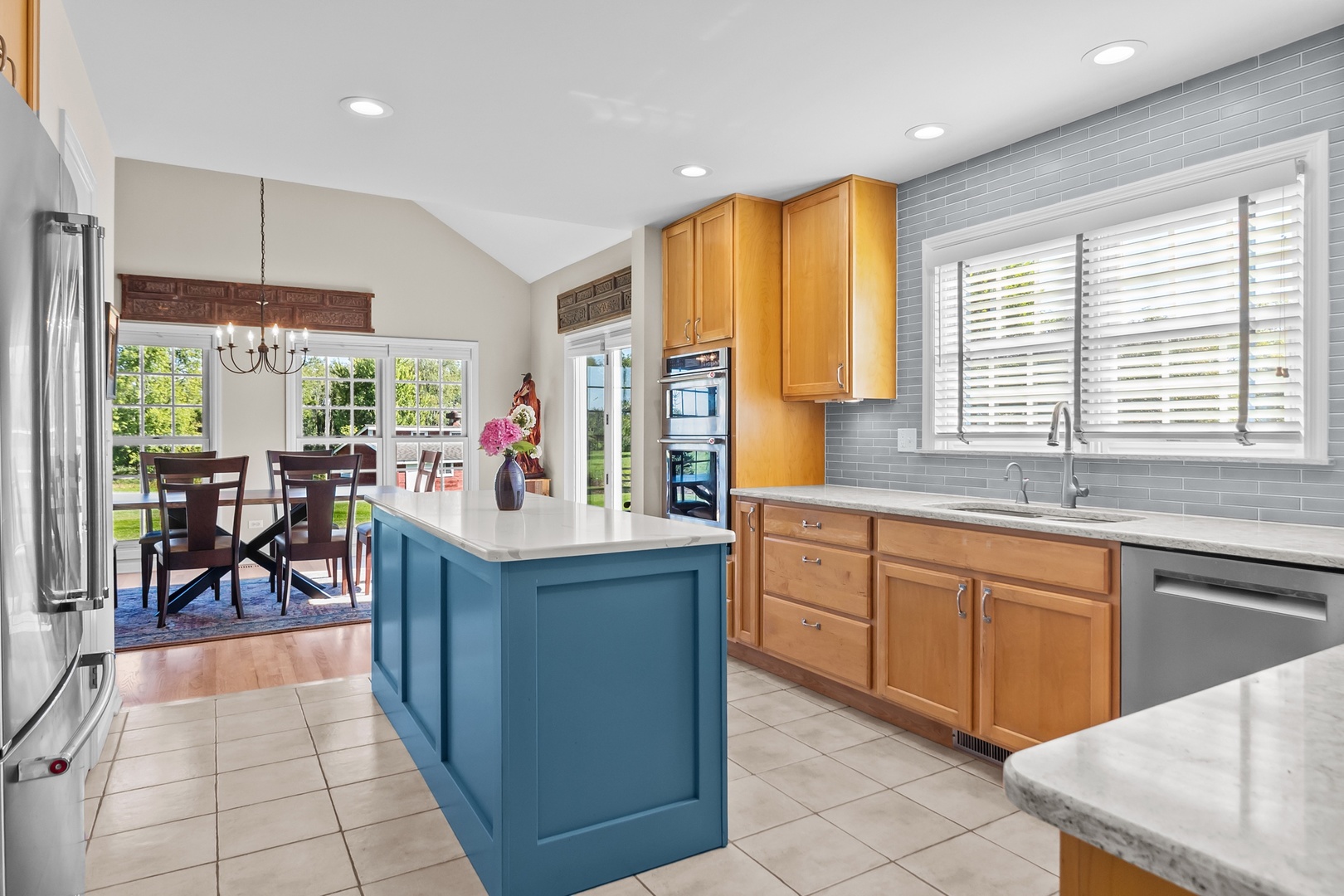 19303 McGuire Road Harvard, IL 60033 - Photo 23 of 36 a kitchen with stainless steel appliances granite countertop sink window and chairs