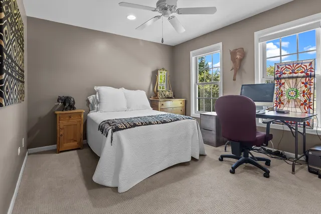 a view of a hallway with wooden floor and windows