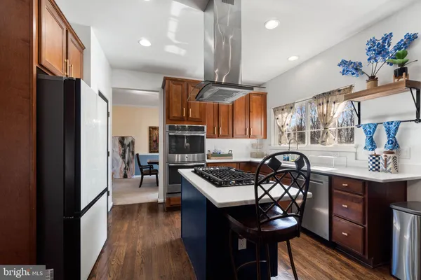 a kitchen with stainless steel appliances granite countertop a stove refrigerator and a sink