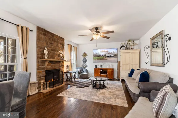 a living room with furniture fireplace and a window