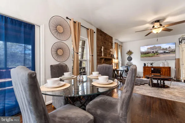 a dining room with furniture a rug and a clock