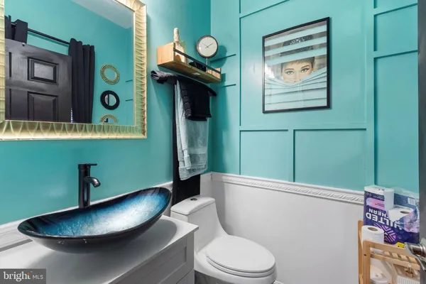 a bathroom with a toilet and a mirror