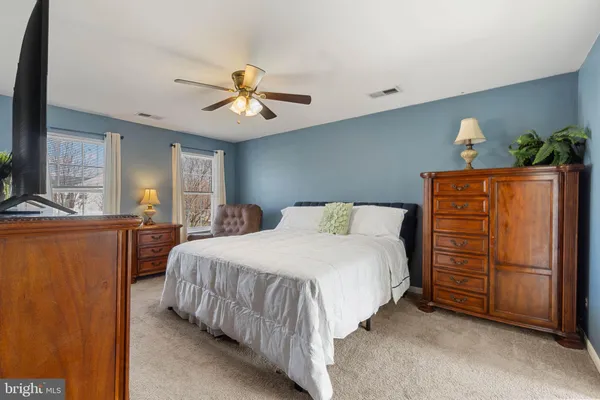 a bedroom with a bed dresser and a window