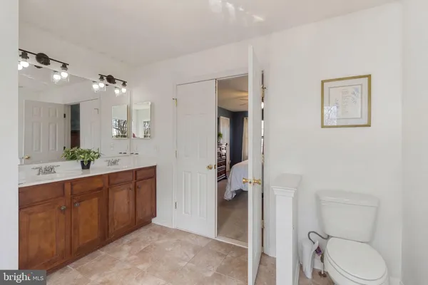 a spacious bathroom with a toilet sink shower and mirror