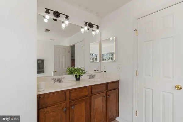 a bathroom with a sink vanity and mirror