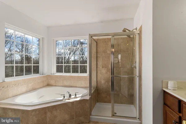 a bathroom with a bathtub and a shower