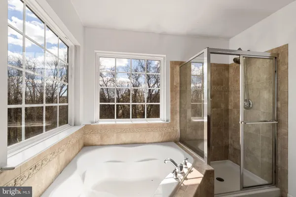 a bathroom with a bathtub and a shower