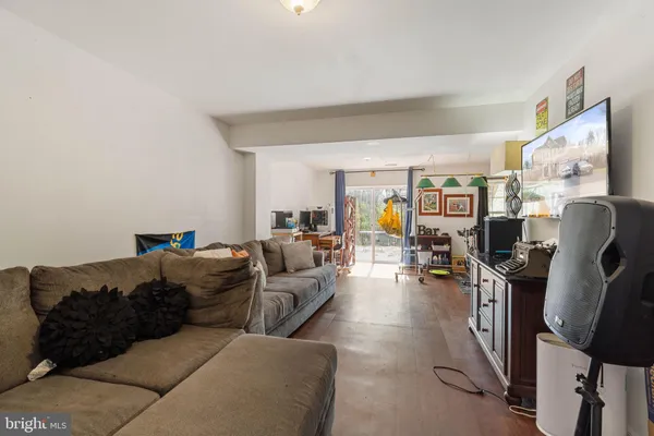 a living room with furniture a couch and a flat screen tv