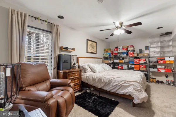 a bedroom with furniture and a large window