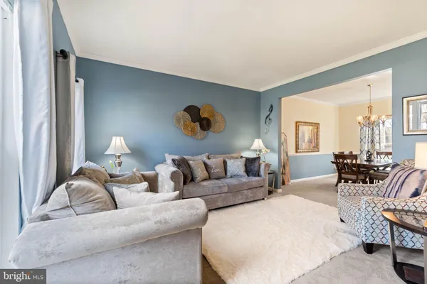 a living room with furniture and a lamp